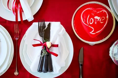 Beautiful table setting on red background, top view. Valentine's Day dinner Stock Photos