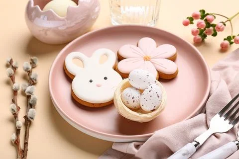 Beautiful table setting with sweet cookies, Easter eggs and pussy willow bran Stock Photos