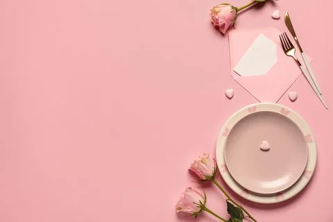 Beautiful table setting for Valentine's Day with rose flowers, envelope and p Stock Photos
