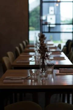 Beautiful table setting with vases and dried flowers, napkins and cutlery Stock Photos