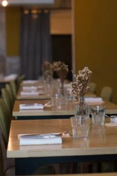 Beautiful table setting with vases and dried flowers, napkins and cutlery Stock Photos