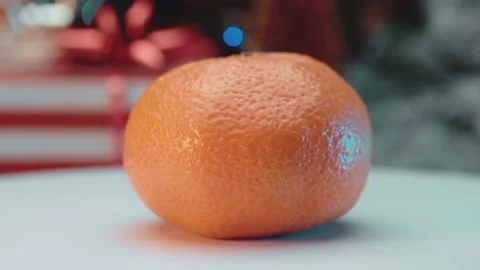 Beautiful tangerine on a background of lights. Stock Footage 145164172