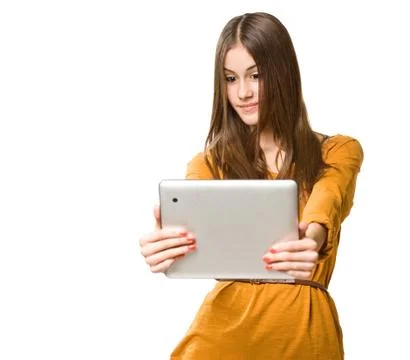 Beautiful teen using tablet computer. Stock Photos