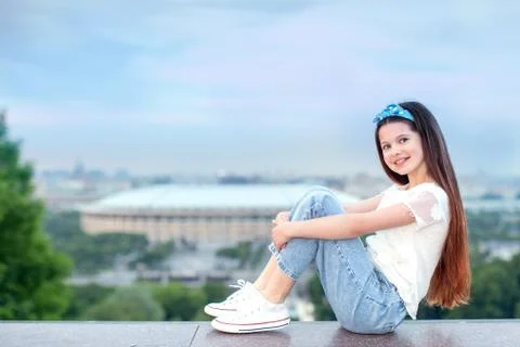 Beautiful teenage girl student the city at sunset panorama Stock Photos