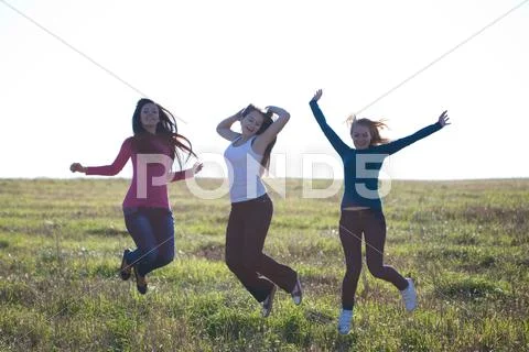 Beautiful teenager woman jumping outdoors Stock Photos