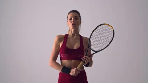 The beautiful tennis player is posing on camera in studio. slow motion Stock Footage 132854293
