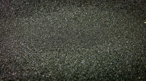 Beautiful texture of black sand beach and macro closeup rotation. Video stock 61135576