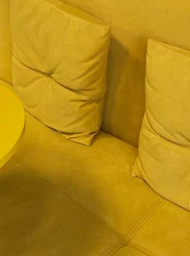 Beautiful texture. Yellow sofa close-up. Yellow delicate background Stock Photos