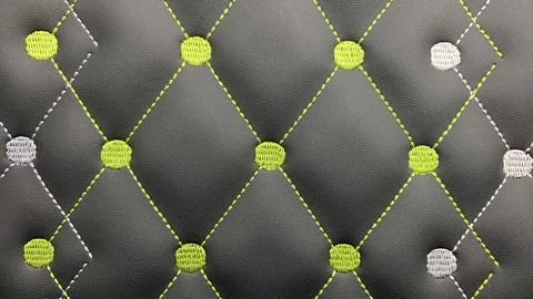 Beautiful thread stitching and embroidery on the black leather. Stock Photos