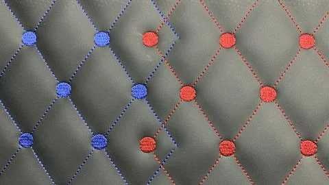 Beautiful thread stitching and embroidery on the black leather. Stock Photos