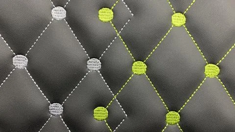 Beautiful thread stitching and embroidery on the black leather. Stock Photos