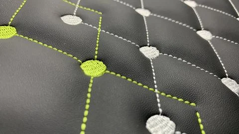 Beautiful thread stitching and embroidery on the black leather. Stock Photos