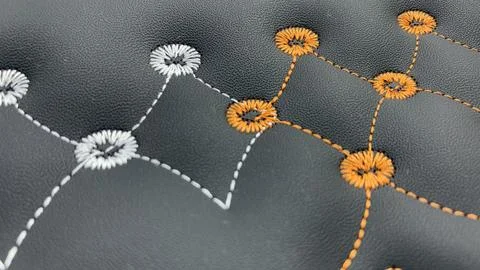 Beautiful thread stitching and embroidery on the black leather Stock Photos