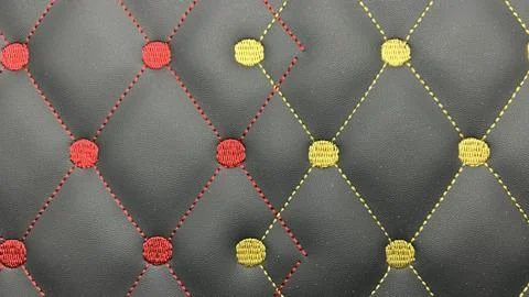Beautiful thread stitching and embroidery on the black leather Stock Photos