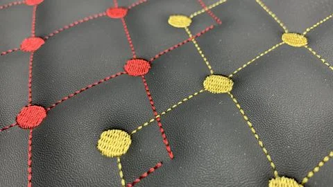 Beautiful thread stitching and embroidery on the black leather Stock Photos