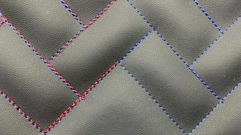 Beautiful thread stitching on the black leather Stock Photos