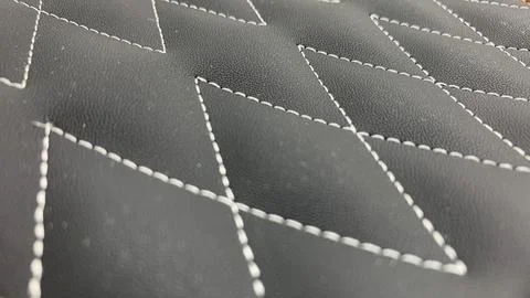 Beautiful thread stitching on the black leather. Stock Photos