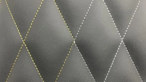 Beautiful thread stitching on the black leather. Stock Photos
