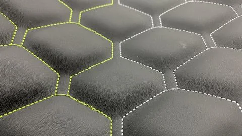 Beautiful thread stitching on the black leather. Stock Photos