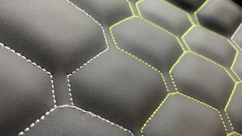 Beautiful thread stitching on the black leather. Stock Photos