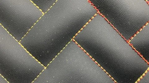 Beautiful thread stitching on the black leather. Stock Photos