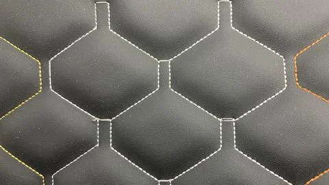 Beautiful thread stitching on the black leather. Stock Photos