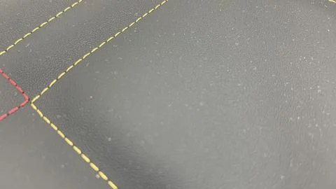 Beautiful thread stitching on the black leather Stock Photos