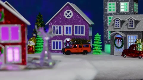 A beautiful three-colored house rotates among a Christmas tree and a car Stock Footage 313259944