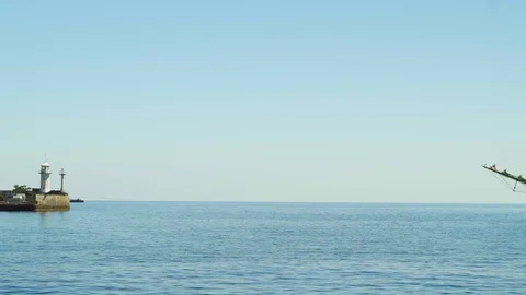 A beautiful three-sailing ship is sailing to the port in Yalta 4k Video stock 113879922