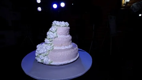 Beautiful three-tier wedding cake stands on the table 動画素材 114022413