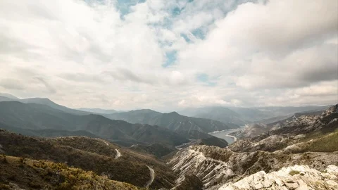 Beautiful time lapse of clouds above a lake. Landscape from a mountain Kozjak Stock Footage