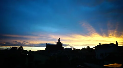 Beautiful time lapse of clouds moving over a church at sunset Stock Footage 65001530