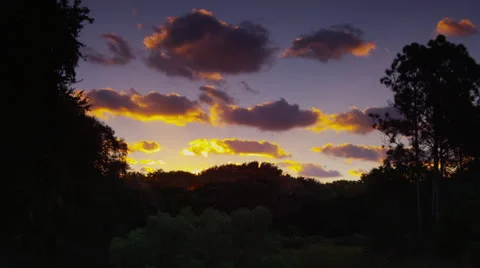 Beautiful Time lapse of colorful clouds moving over the forest. Stock Footage 64659518