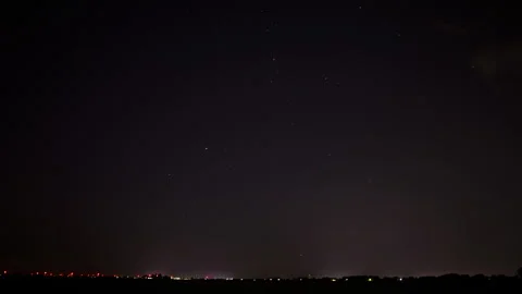 Beautiful time lapse of a distant highway at night while the camera zooms in. Stock Footage 282343744