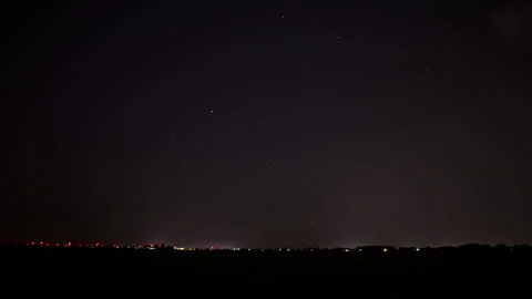 Beautiful time lapse of a distant highway at night. The camera pans Stock Footage 282345567