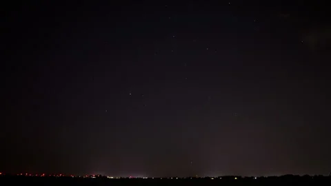 Beautiful time lapse of a distant highway at night while the camera zooms out. Stock Footage 282348455