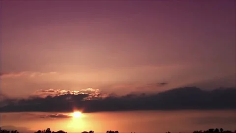Beautiful Time-Lapse of dramatic sky. Sunset or sunrise orange could. Sunset Stock Footage 280330458