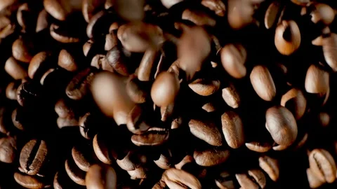 Beautiful time-lapse footage of falling coffee beans 4K. Slow motion of roasted Stock Footage 268369941