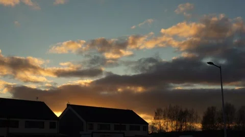 Beautiful time-lapse of rapidly moving clouds against stunning sunset sky Stock Footage 293752821