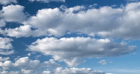 Beautiful time lapse of white clouds with blue sky coming to camera Video stock 127690856