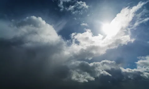 Beautiful timelapse of grey fluffy clouds gradually covering sunny blue sky. Stock Footage 132369655