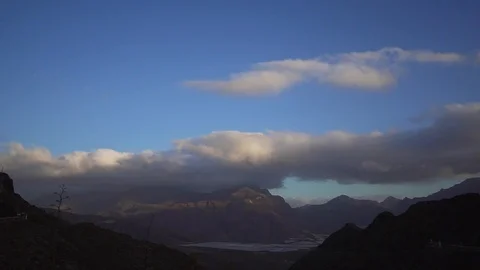 Beautiful timelapse is a high mountain with fast moving clouds over the valley Stock Footage 116706673