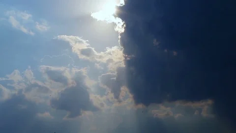 Beautiful timelapse with large clouds and sunshine breaking through cloud mass. Stock Footage 78969893