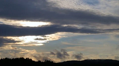 Beautiful timelapse with large clouds and sunshine breaking through cloud mass. Stock Footage 79668515