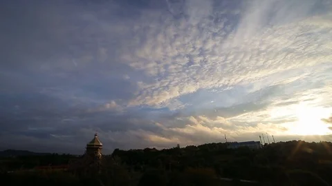 Beautiful timelapse with large clouds and sunshine breaking through cloud mass. Stock Footage 79668569