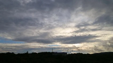 Beautiful timelapse with large clouds and sunshine breaking through cloud mass. Video stock 79668626