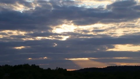 Beautiful timelapse with large clouds and sunshine breaking through cloud mass. Video stock 79845574