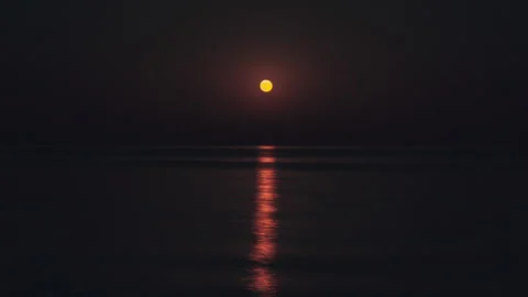 Beautiful Timelapse Moon Path on the Water. The Full Red Moon Shines Brightly in Stock Footage 166752421