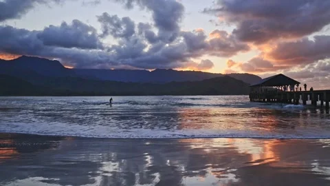  Beautiful timelapse shot of a sunset sky over Hanalei Pier with flowing sea  Stock Footage 202105192