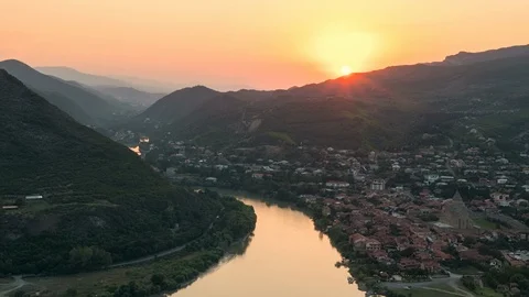 Beautiful timelapse of sun setting over mountains behind the old Georgian town Stock Footage 106646381